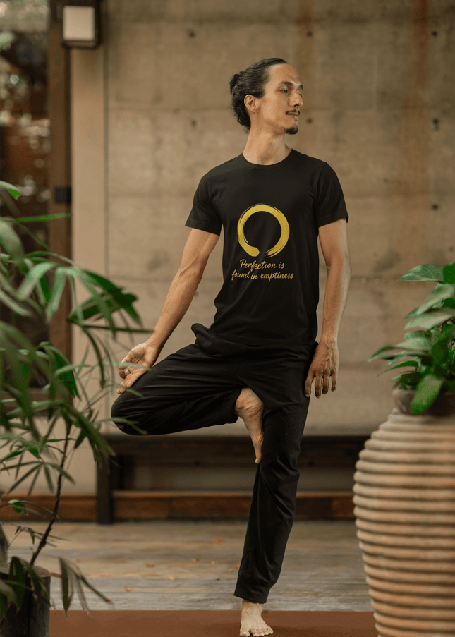 Mann in Perfection Herren T-Shirt in Handstand-Pose, umgeben von Pflanzen, Symbol für Zen und Klarheit.